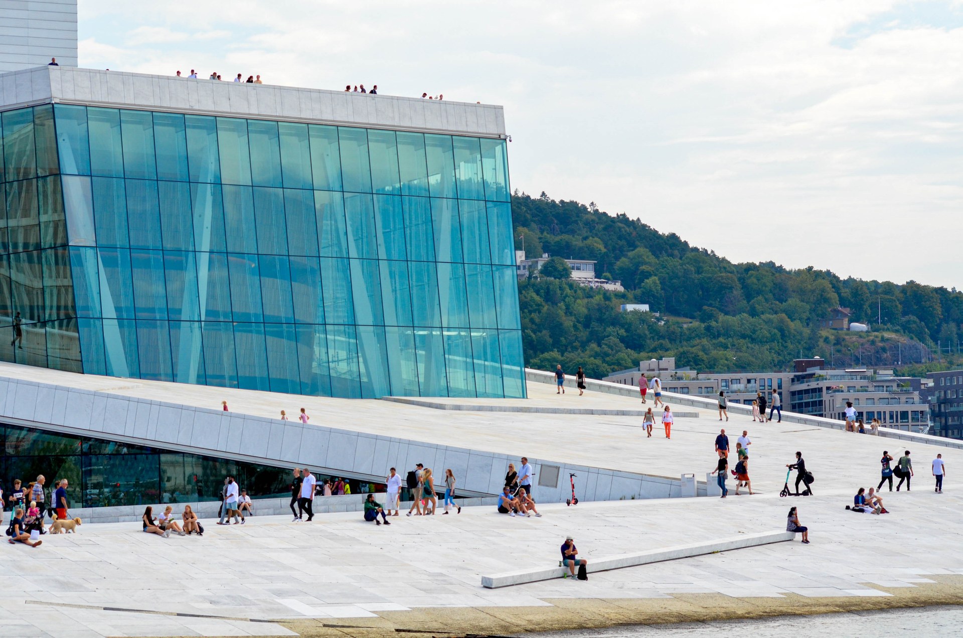People walking and relaxing on the roof of the Oslo Opera House